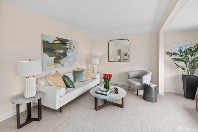 a living room with furniture and a lamp