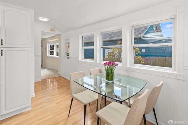 a dining room with furniture and wooden floor