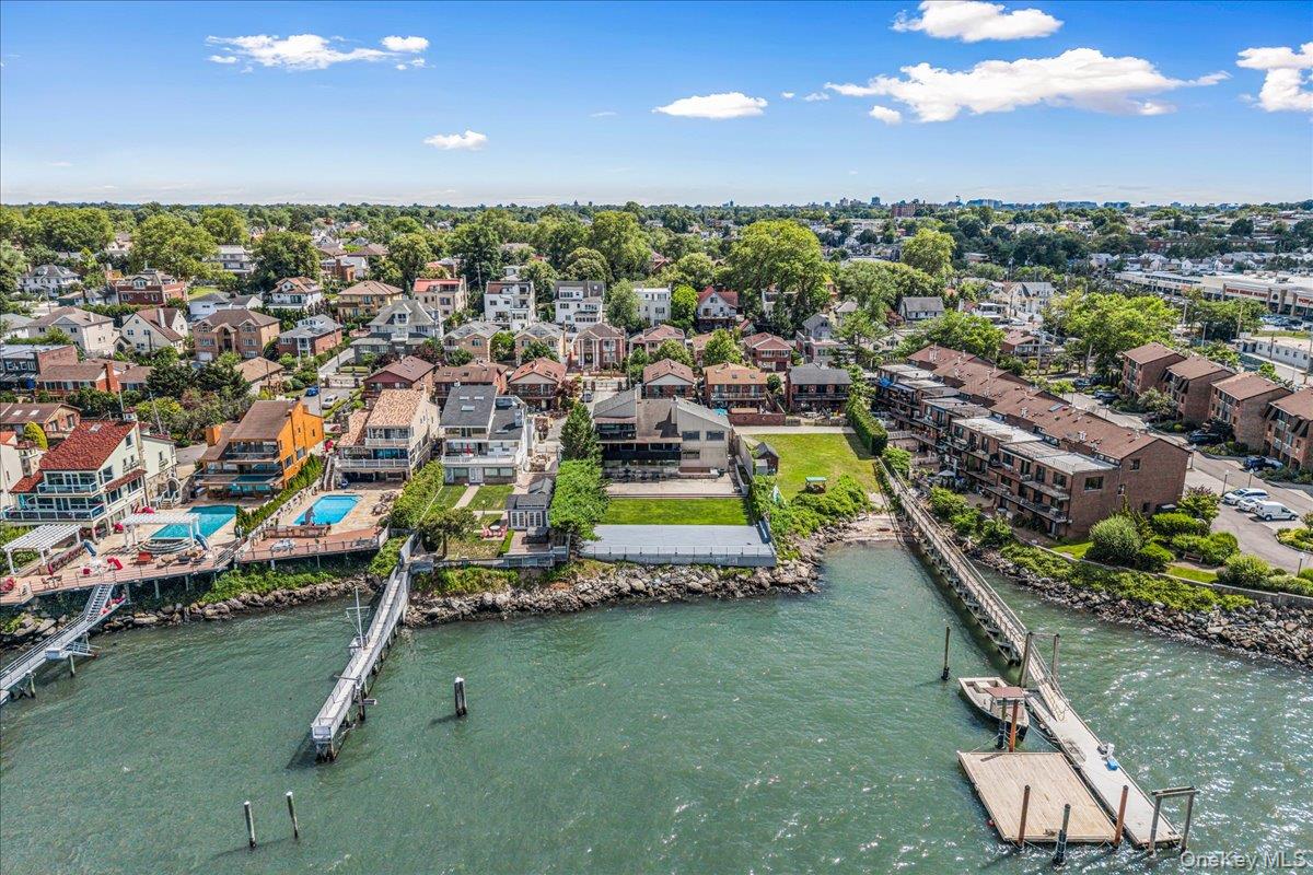 154-43 Riverside Drive Queens, NY 11357 - Photo 2 of 41 an aerial view of a house with a garden and swimming pool
