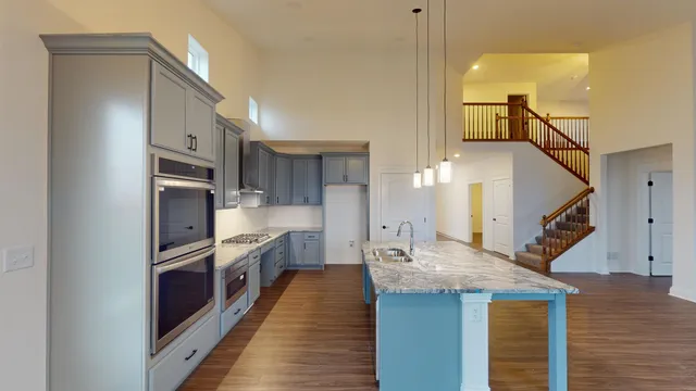 a kitchen with cabinets and stainless steel appliances