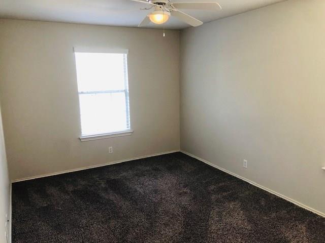 1608 Tristan Way Cedar Park, TX 78613 - Photo 12 of 18 Empty room with dark colored carpet and a ceiling fan