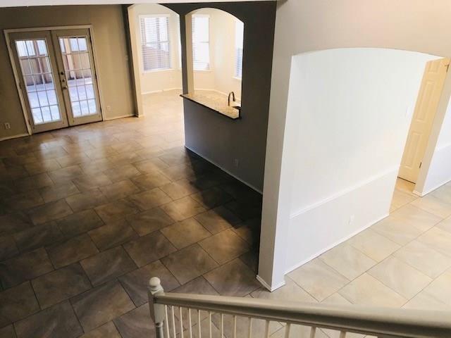 1608 Tristan Way Cedar Park, TX 78613 - Photo 4 of 18 Empty room with arched walkways and french doors