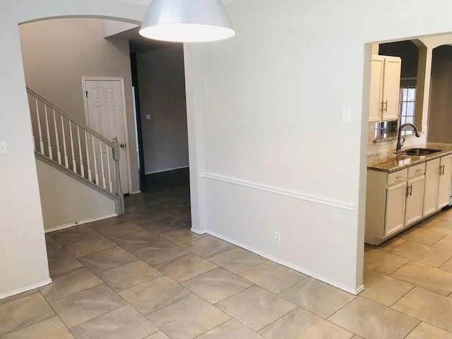 1608 Tristan Way Cedar Park, TX 78613 - Photo 8 of 18 Unfurnished dining area featuring arched walkways and stairway