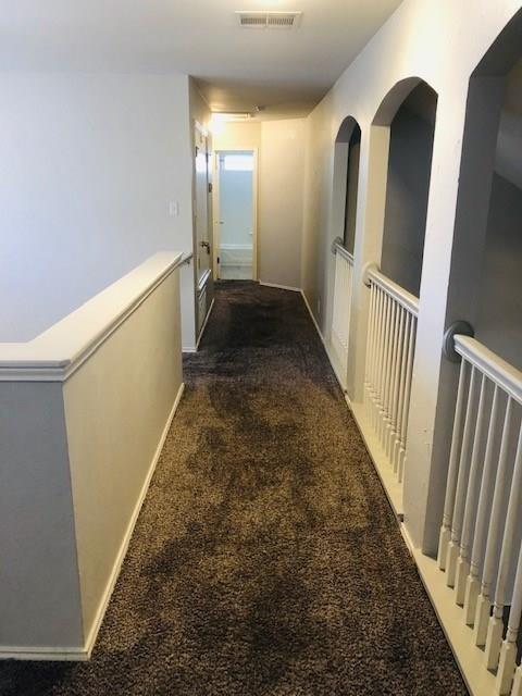 1608 Tristan Way Cedar Park, TX 78613 - Photo 10 of 18 Corridor featuring dark colored carpet and an upstairs landing