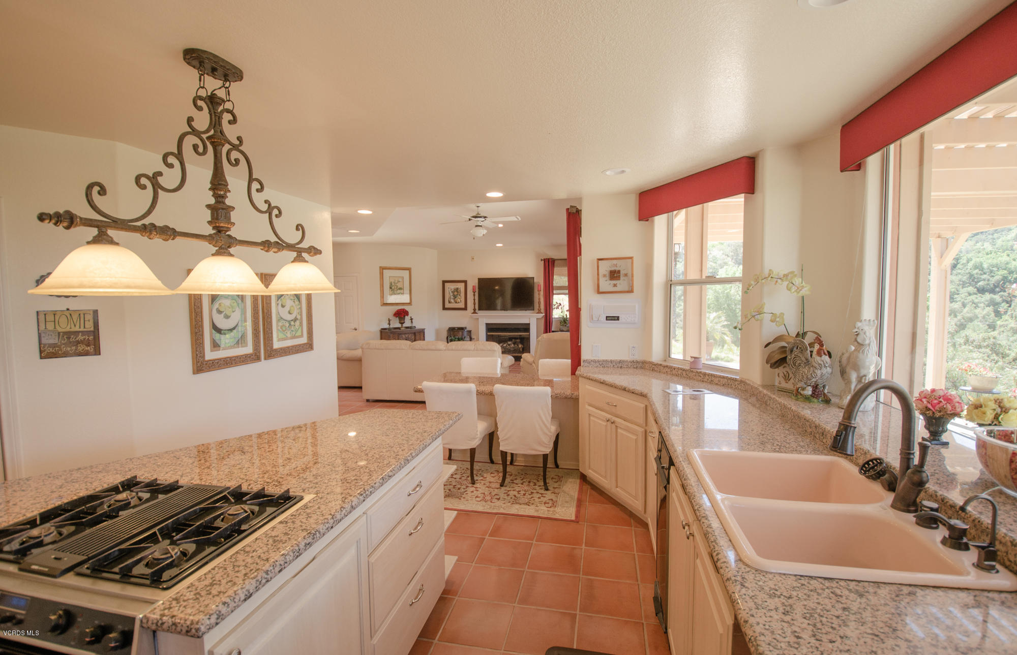 180 Sundown Road Thousand Oaks, CA 91361 - Photo 11 of 32 a large white kitchen with sink a stove and a window