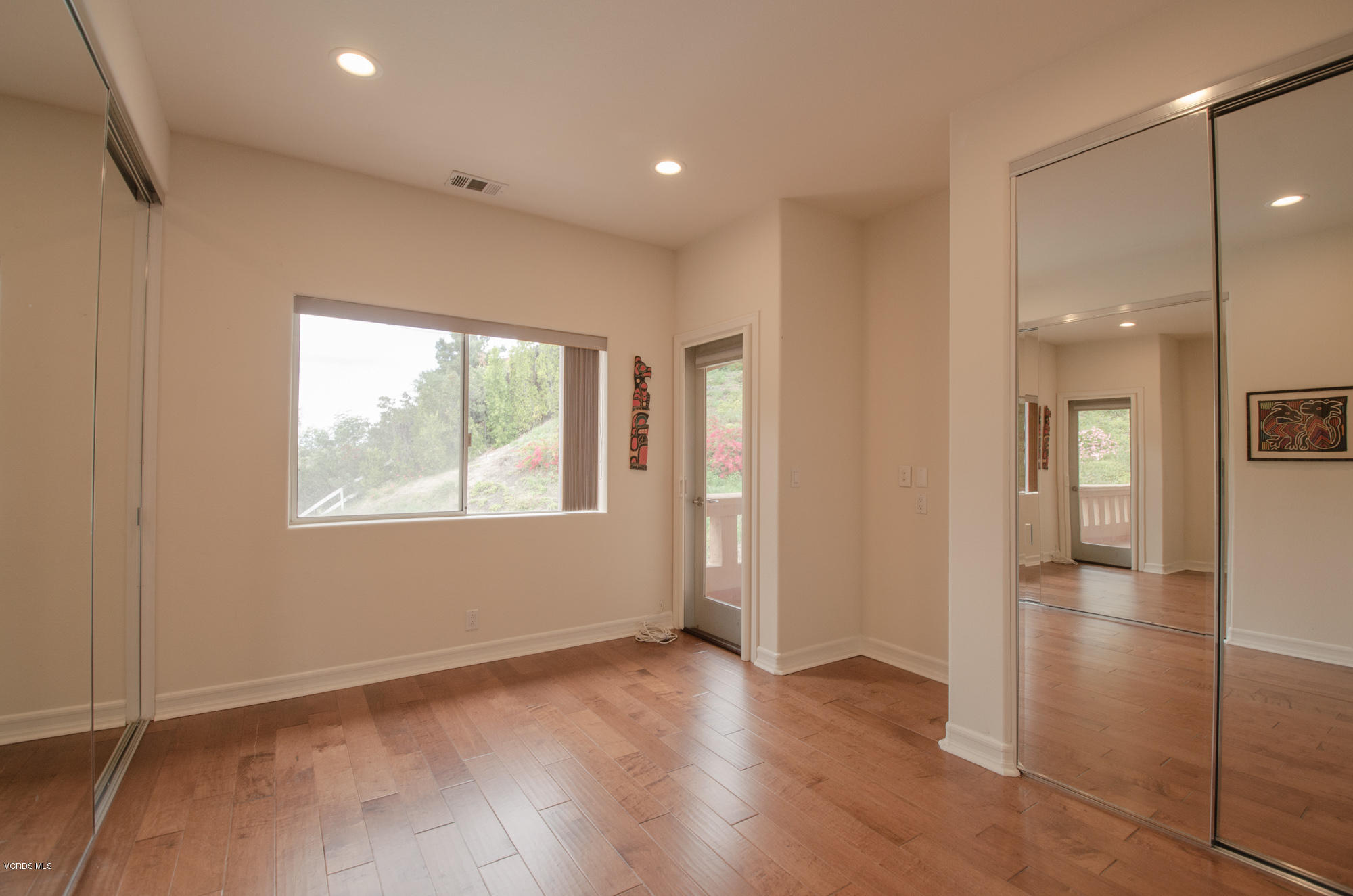 180 Sundown Road Thousand Oaks, CA 91361 - Photo 19 of 32 an empty room with wooden floor and windows