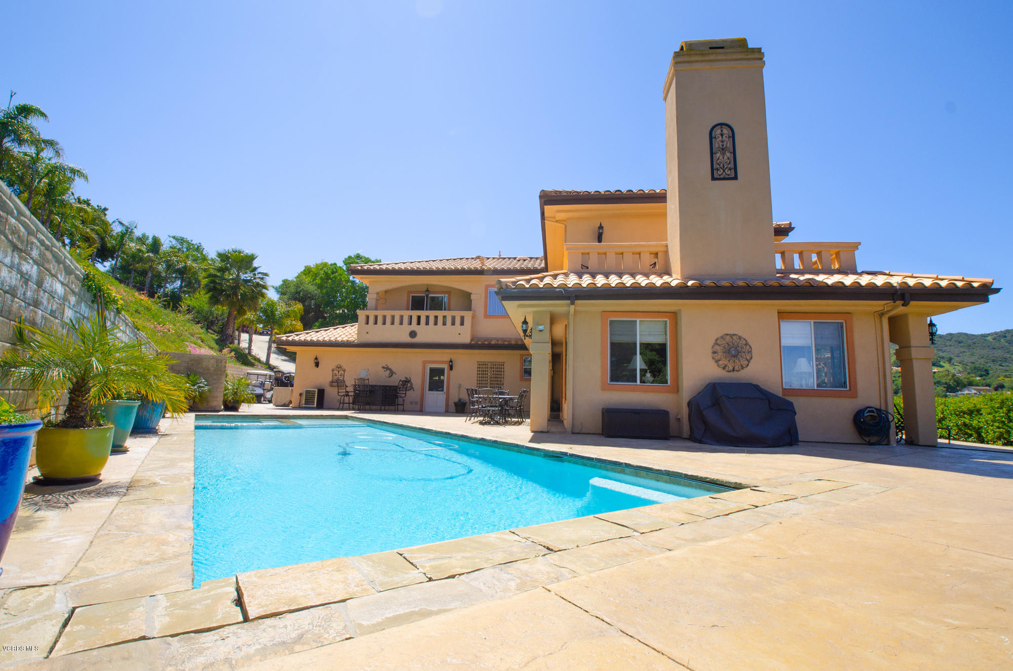 180 Sundown Road Thousand Oaks, CA 91361 - Photo 21 of 32 a front view of a house with a yard and potted plants