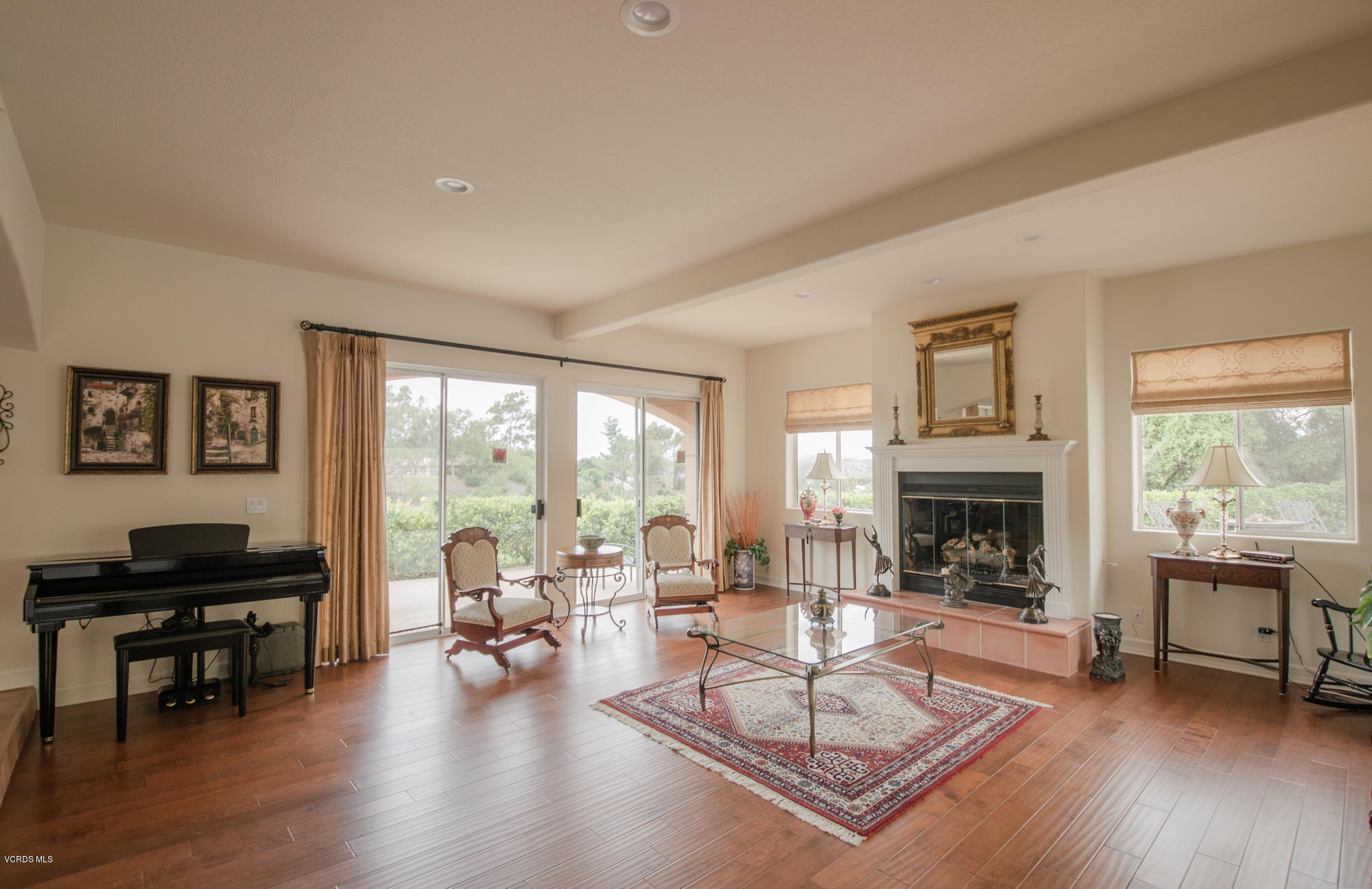 180 Sundown Road Thousand Oaks, CA 91361 - Photo 8 of 32 a living room with furniture a fireplace and a table