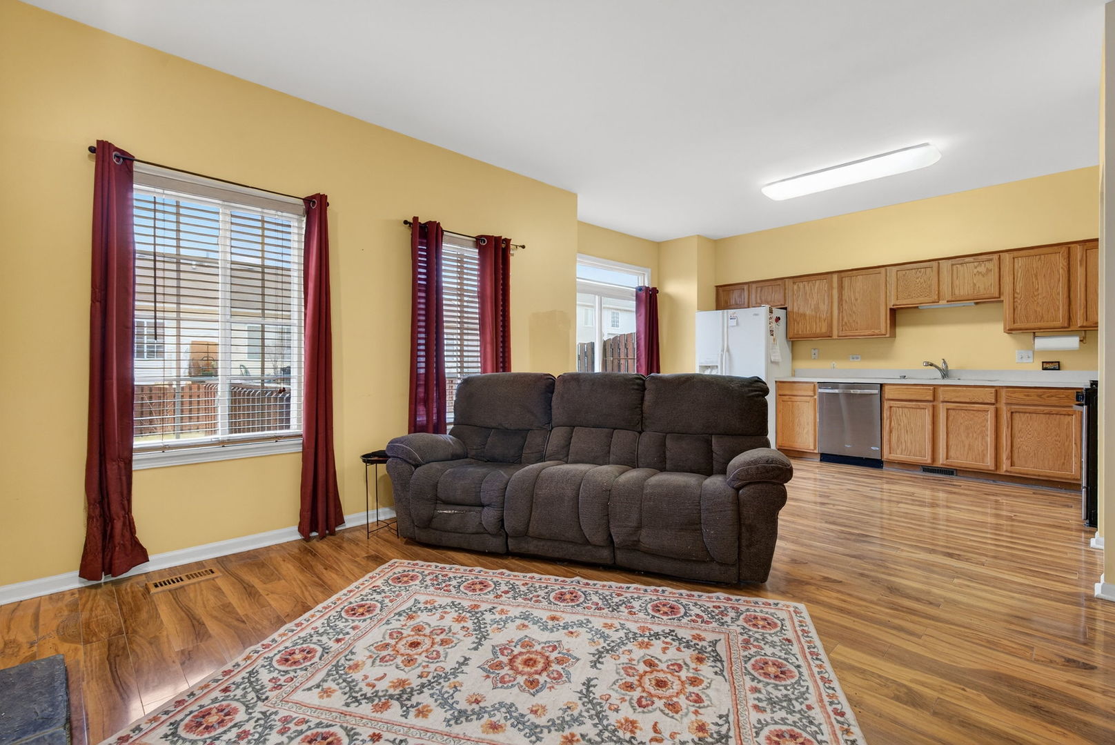 1451 Red Top Lane Minooka, IL 60447 - Photo 14 of 37 a living room with a couch and dresser with wooden floor