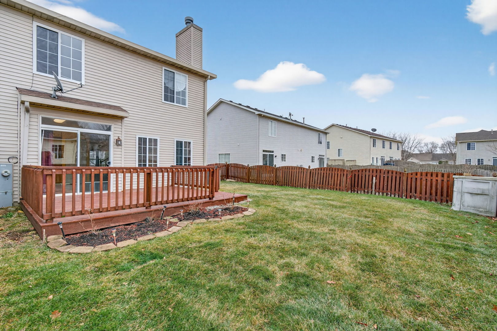 1451 Red Top Lane Minooka, IL 60447 - Photo 32 of 37 a view of a house with backyard and deck
