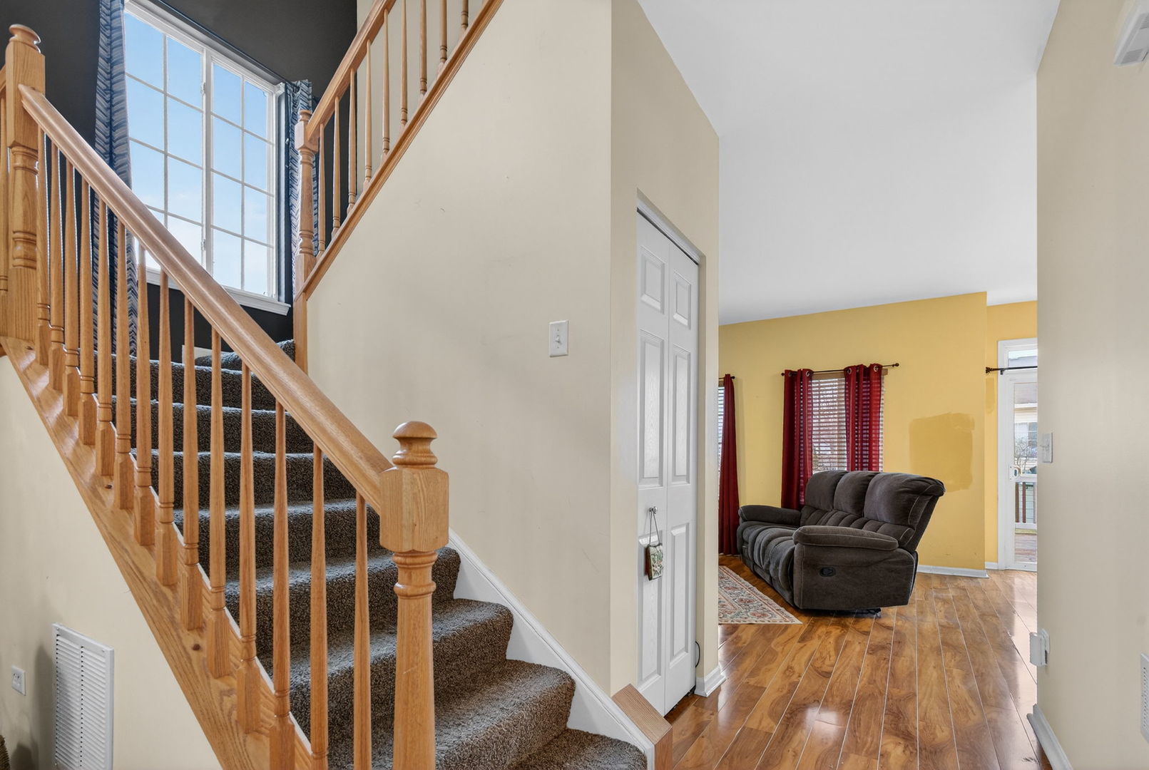 1451 Red Top Lane Minooka, IL 60447 - Photo 7 of 37 a view of a hallway with wooden floor and staircase