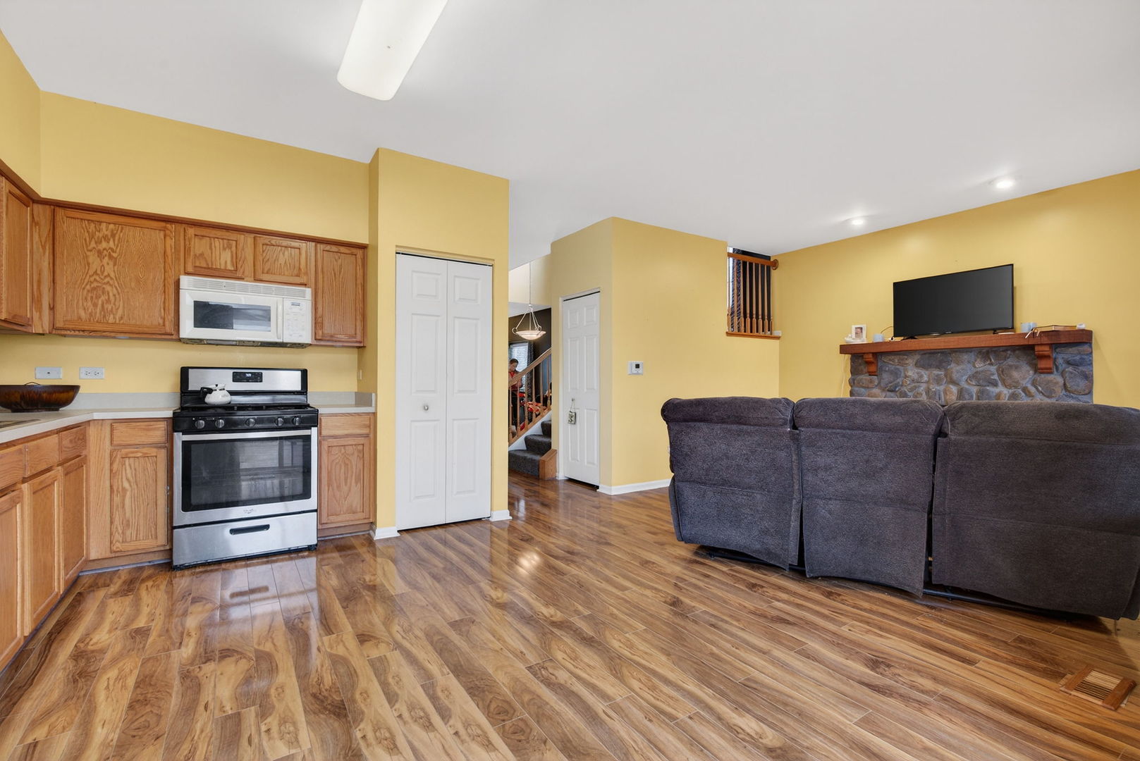 1451 Red Top Lane Minooka, IL 60447 - Photo 8 of 37 a kitchen with stainless steel appliances granite countertop a stove a sink and a refrigerator