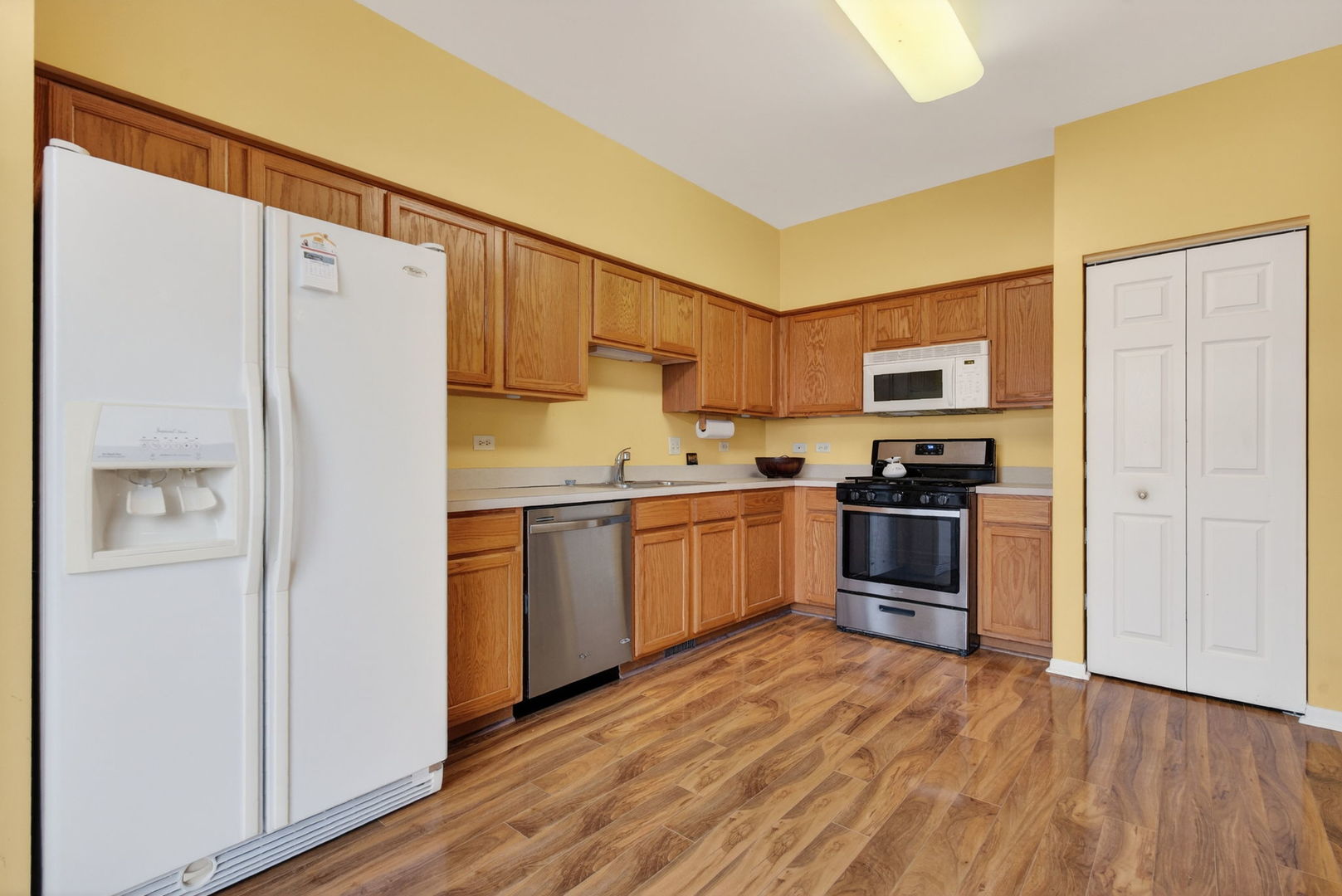 1451 Red Top Lane Minooka, IL 60447 - Photo 9 of 37 a kitchen with a refrigerator a stove top oven a sink and dishwasher with wooden floor