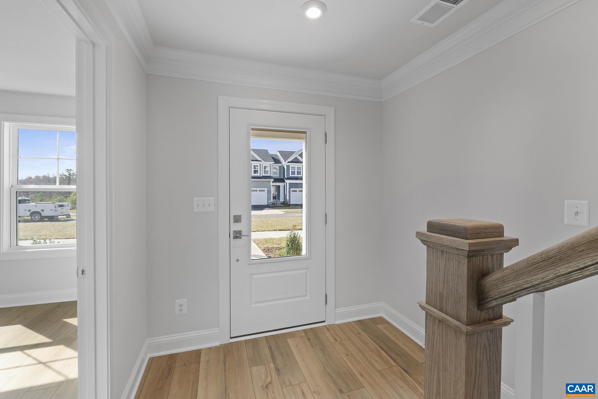 2269 Woodburn Road Charlottesville, VA 22901 - Photo 2 of 39 a view of an empty room with wooden floor and a window