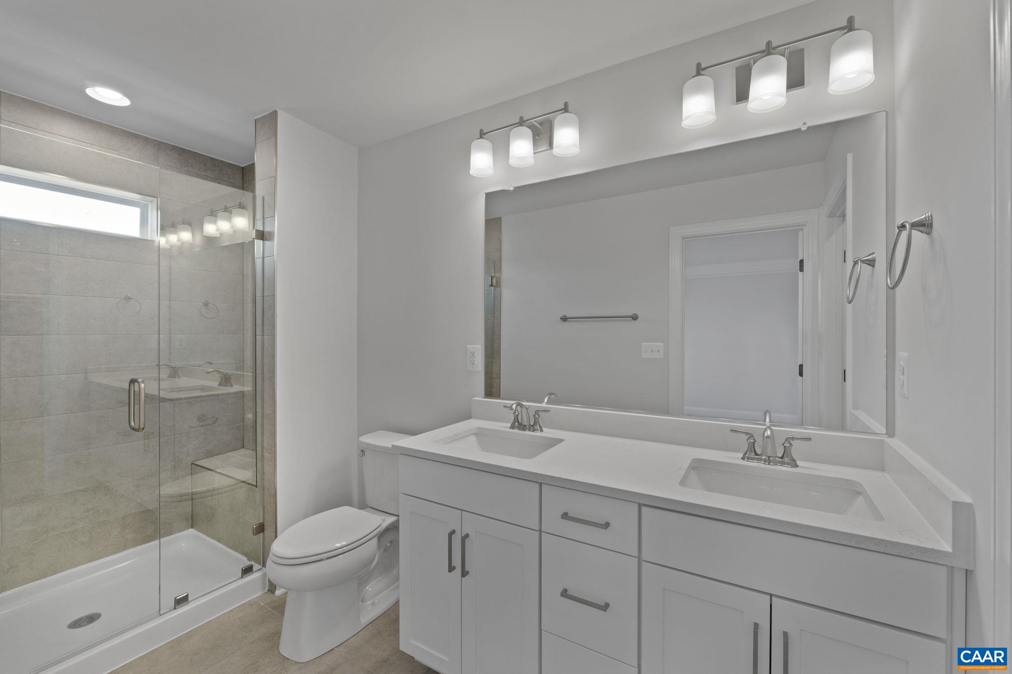 2269 Woodburn Road Charlottesville, VA 22901 - Photo 22 of 39 a bathroom with a toilet a sink a mirror a shower a vanity and window