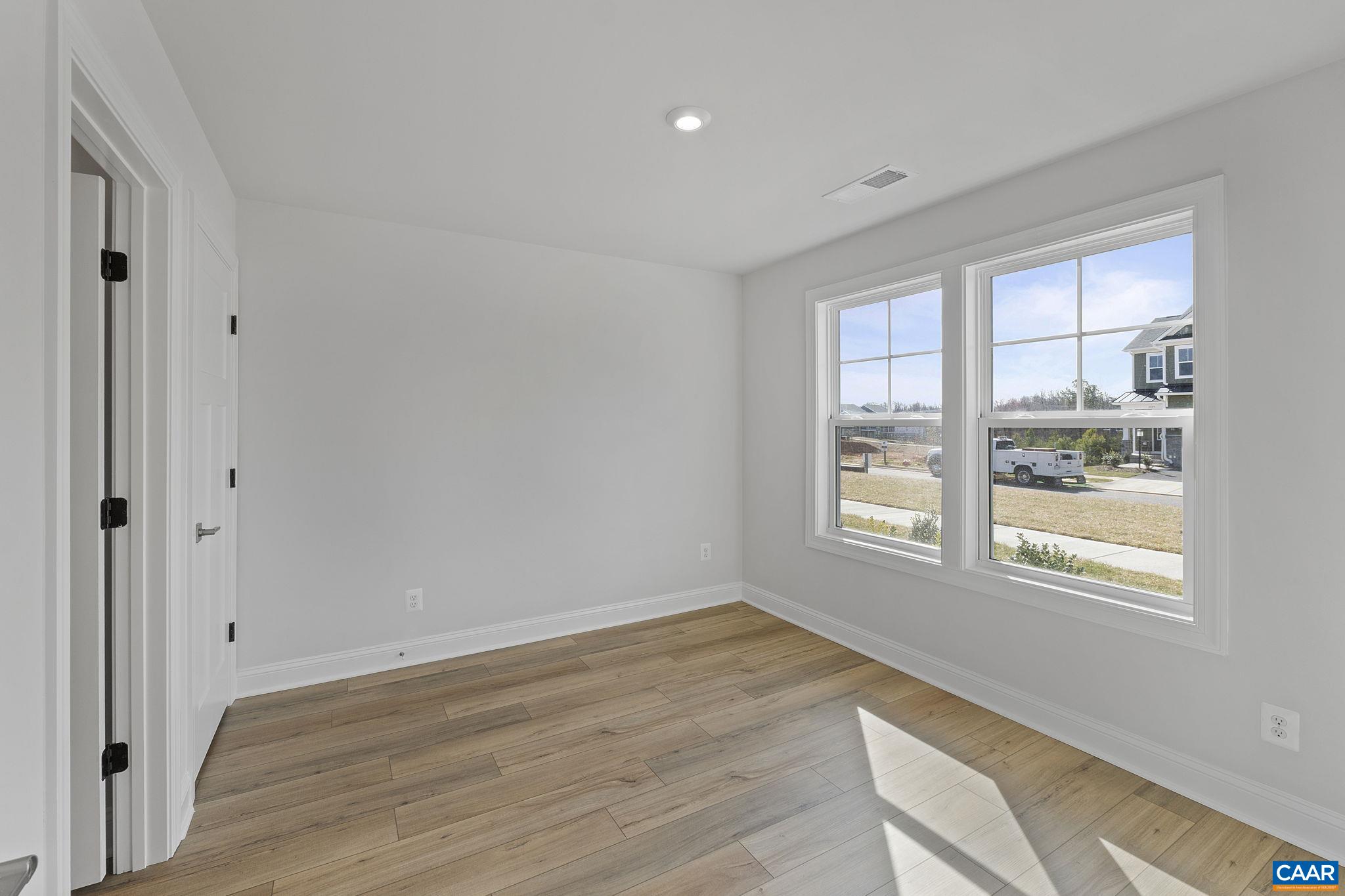 2269 Woodburn Road Charlottesville, VA 22901 - Photo 5 of 39 a view of an empty room with wooden floor and a window