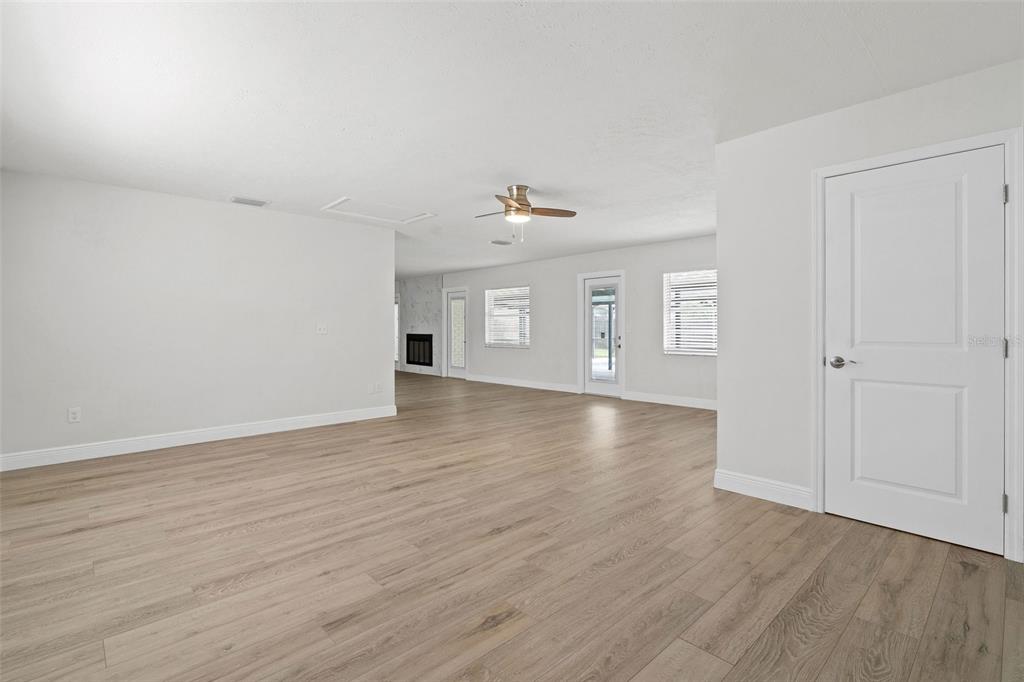 5207 Burr Place Seffner, FL 33584 - Photo 14 of 34 an empty room with wooden floor and windows