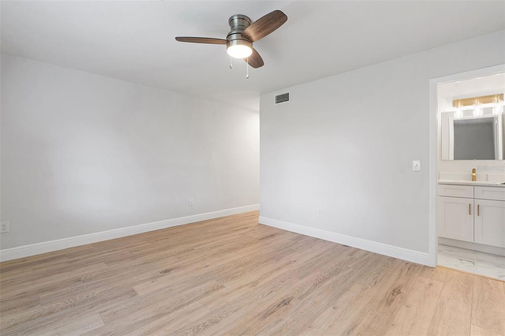 5207 Burr Place Seffner, FL 33584 - Photo 17 of 34 a view of a room with wooden floor and ceiling fan