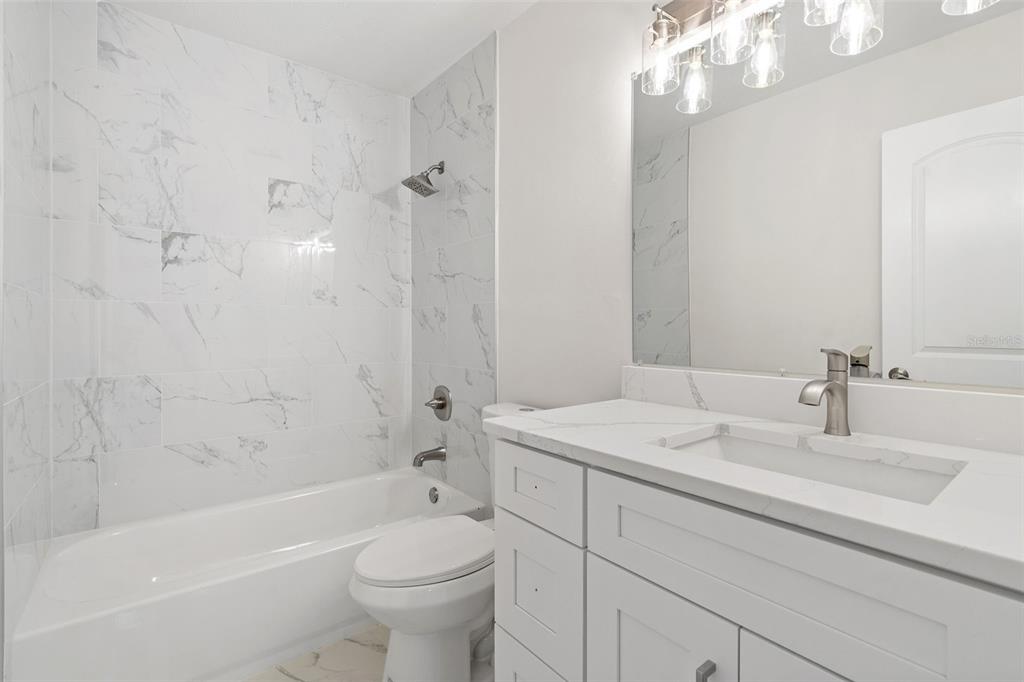 5207 Burr Place Seffner, FL 33584 - Photo 20 of 34 a bathroom with a sink a toilet and shower