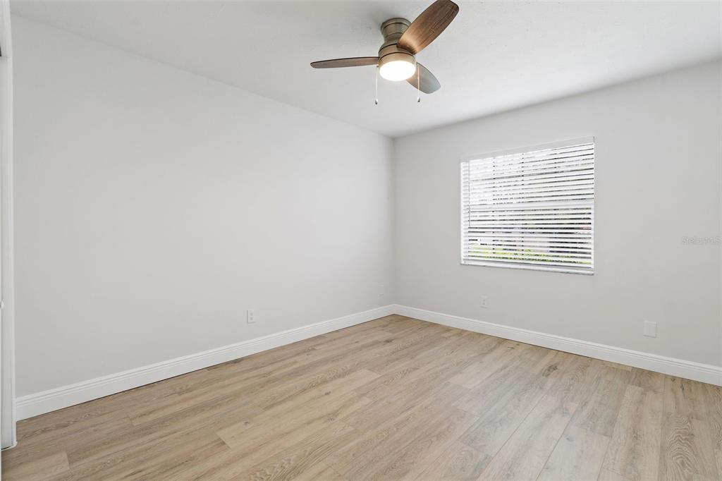5207 Burr Place Seffner, FL 33584 - Photo 21 of 34 wooden floor in an empty room with a window