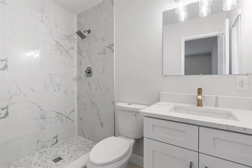 5207 Burr Place Seffner, FL 33584 - Photo 22 of 43 a bathroom with a sink a toilet and shower