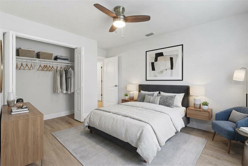 5207 Burr Place Seffner, FL 33584 - Photo 23 of 43 a bedroom with bed and a chandelier