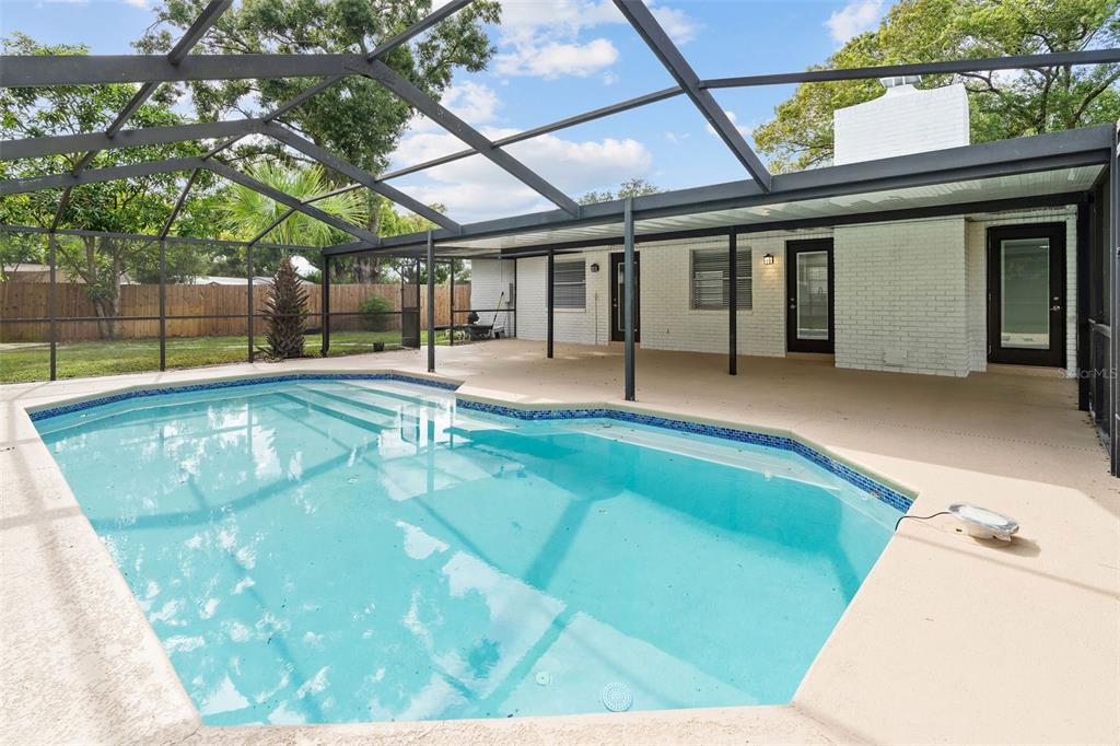 5207 Burr Place Seffner, FL 33584 - Photo 25 of 34 a swimming pool with outdoor seating and yard