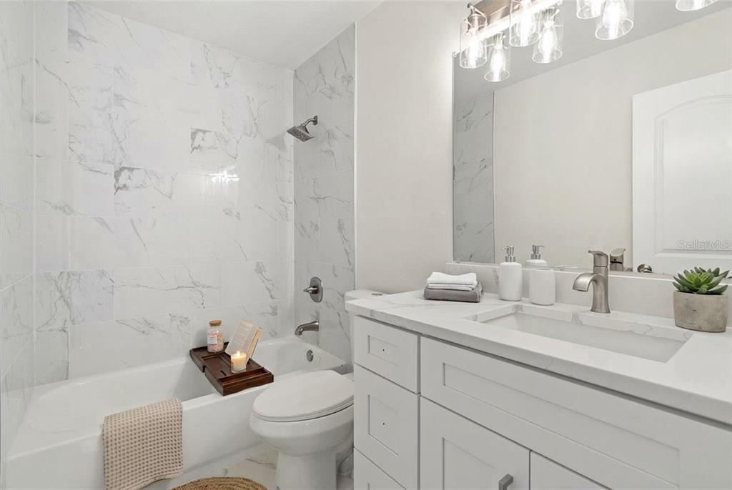 5207 Burr Place Seffner, FL 33584 - Photo 25 of 43 a bathroom with a sink toilet and shower