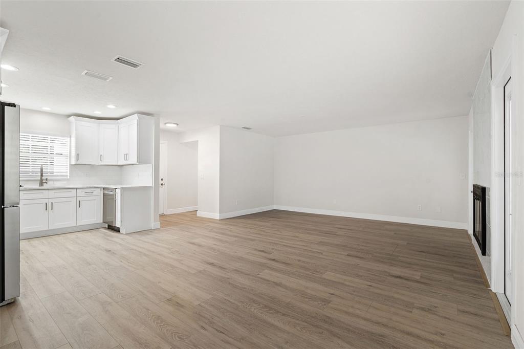 5207 Burr Place Seffner, FL 33584 - Photo 6 of 43 a view of a kitchen with wooden floor and electronic appliances