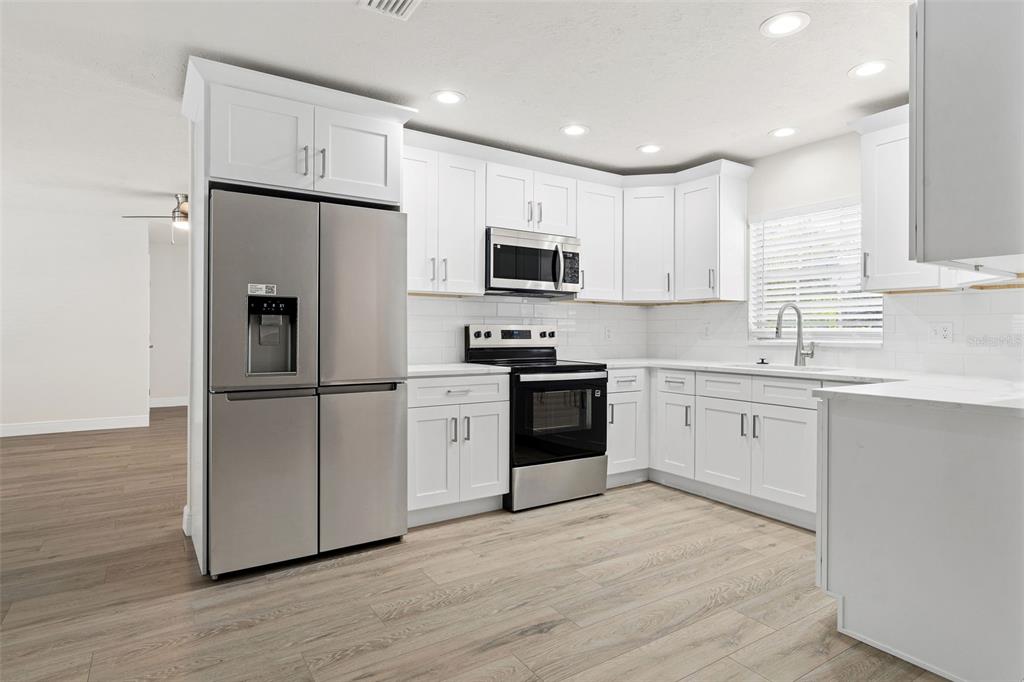 5207 Burr Place Seffner, FL 33584 - Photo 10 of 34 a kitchen with a refrigerator sink and microwave