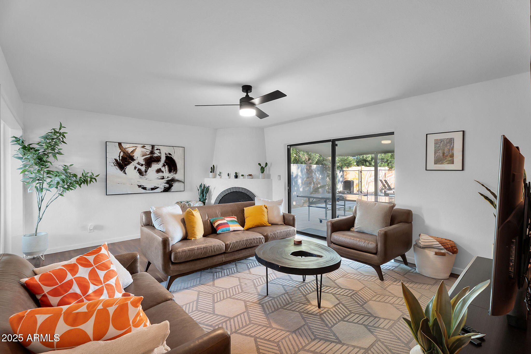 a living room with furniture a rug and a window