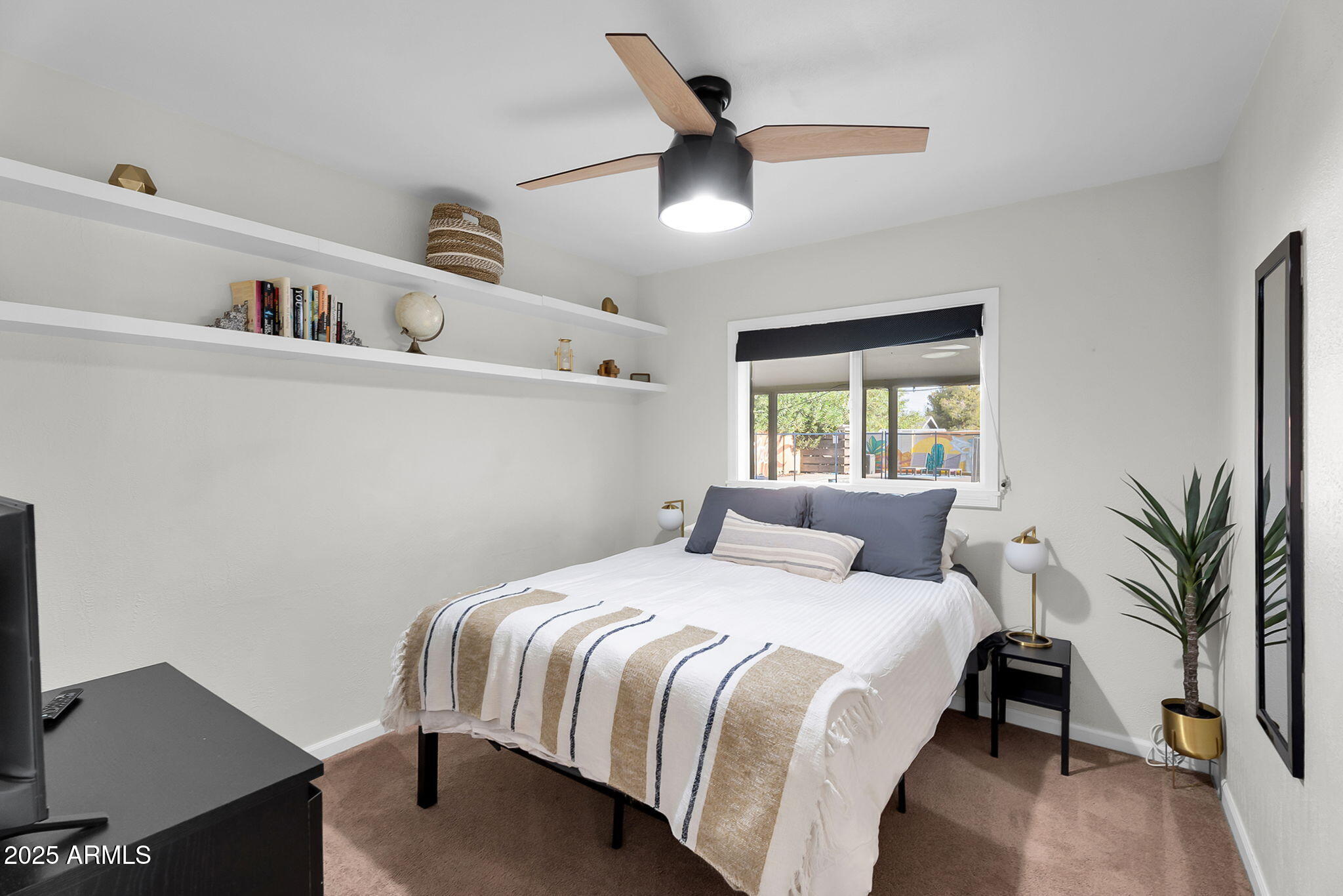 1035 East Pierson Street Phoenix, AZ 85014 - Photo 21 of 34 a bedroom with a large bed and a chandelier