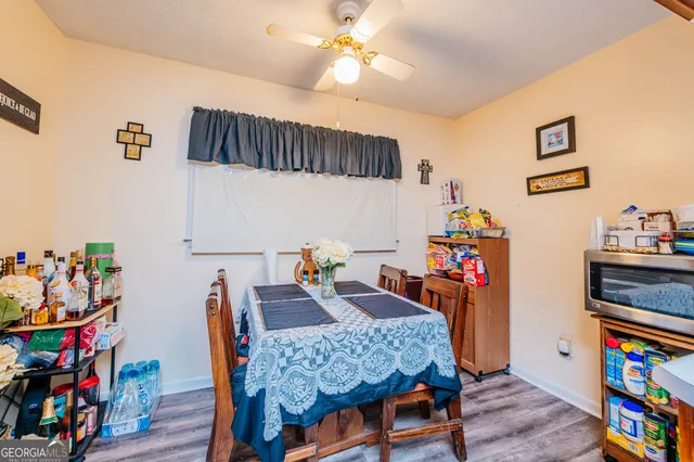 a dining room with furniture and wooden floor