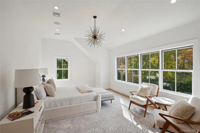 a spacious bathroom with a tub sink and mirror