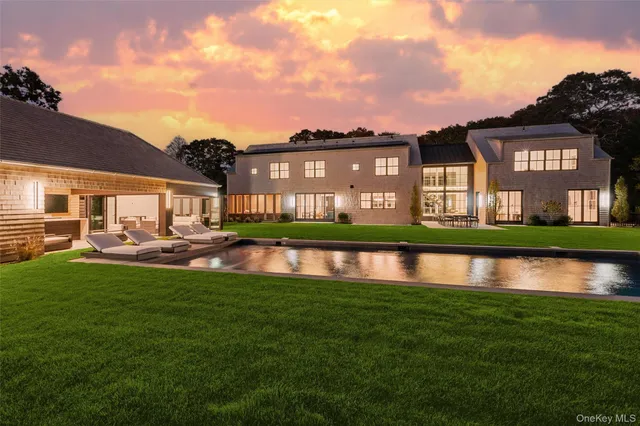a view of a house with backyard porch and sitting area