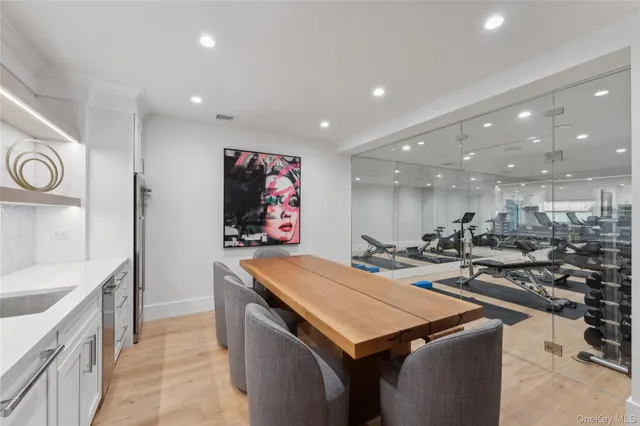 a view of a kitchen with kitchen island a sink wooden floor and a counter top space