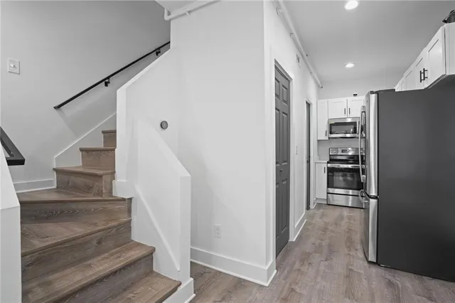 a view of kitchen and hallway with wooden floor