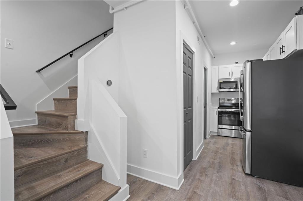 3120 Godby Road, Unit 1107 Atlanta, GA 30349 - Photo 13 of 29 a view of kitchen and hallway with wooden floor