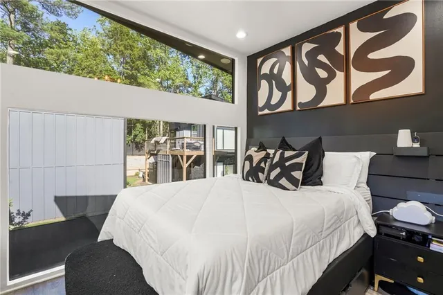 a large bed sitting in a bedroom next to a window