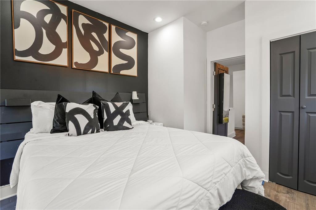 3120 Godby Road, Unit 1107 Atlanta, GA 30349 - Photo 19 of 29 a large bed in a bedroom next to a cabinet
