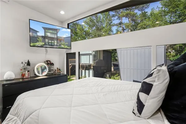 a bedroom with a bed and a large window