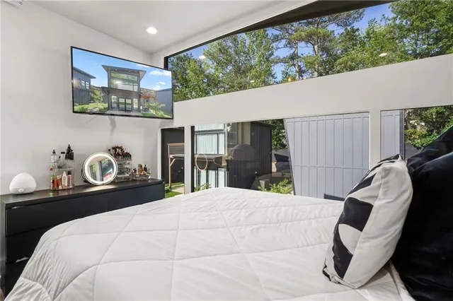 a bedroom with a bed and a large window