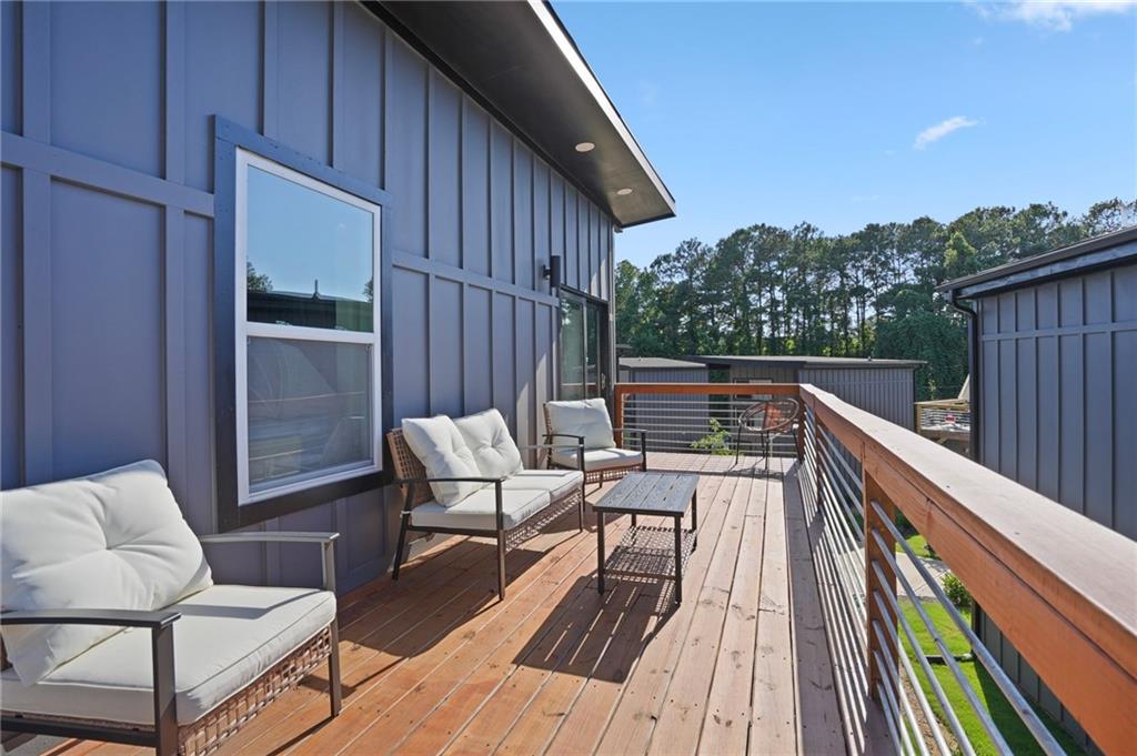 3120 Godby Road, Unit 1107 Atlanta, GA 30349 - Photo 21 of 29 a balcony with wooden floor and outdoor seating