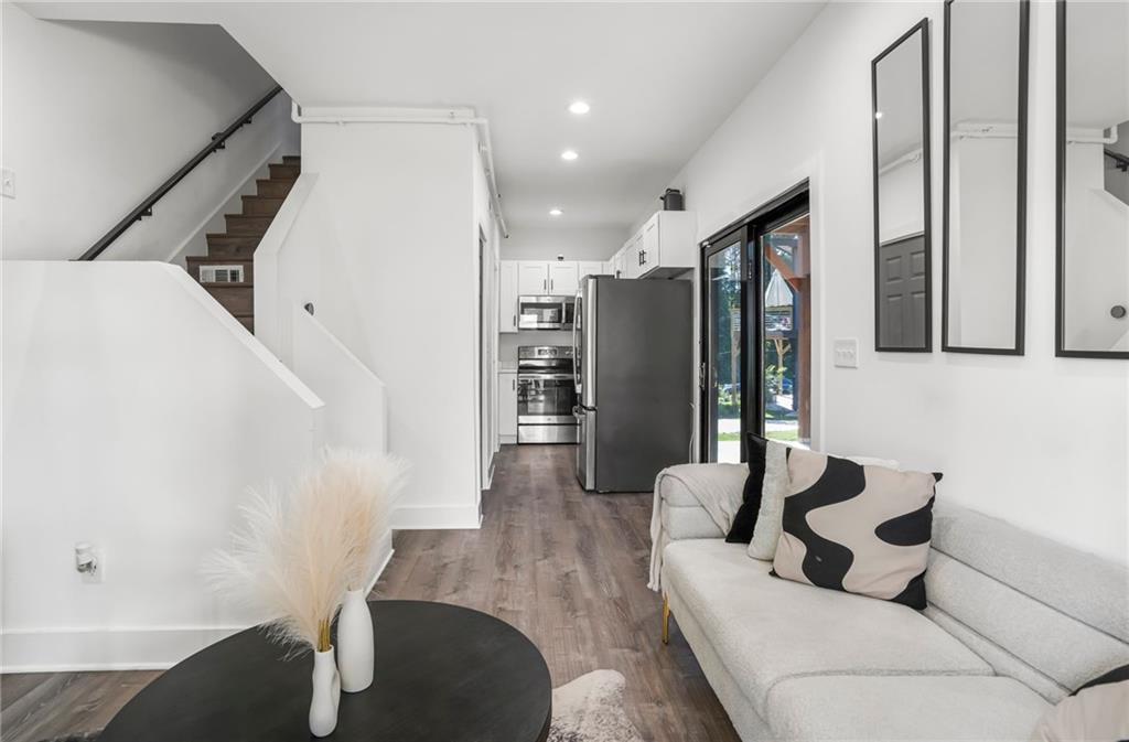 3120 Godby Road, Unit 1107 Atlanta, GA 30349 - Photo 6 of 29 a living room with furniture and a large window