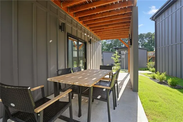 a view of an outside dining space with furniture