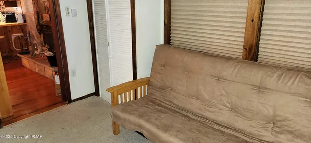 a bedroom with a bed and a flat tv screen on the dresser