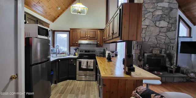 a living room with furniture a rug and a chandelier