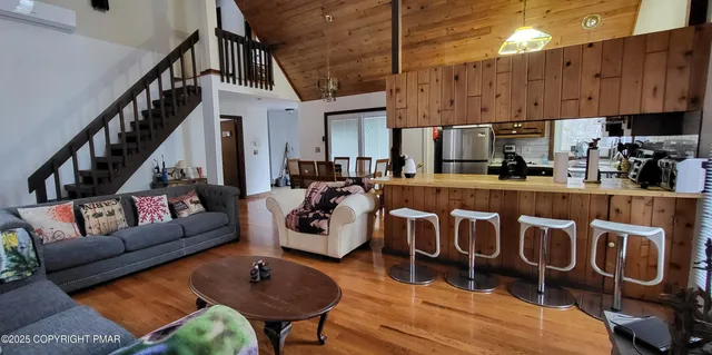 a living room with furniture and a floor to ceiling window