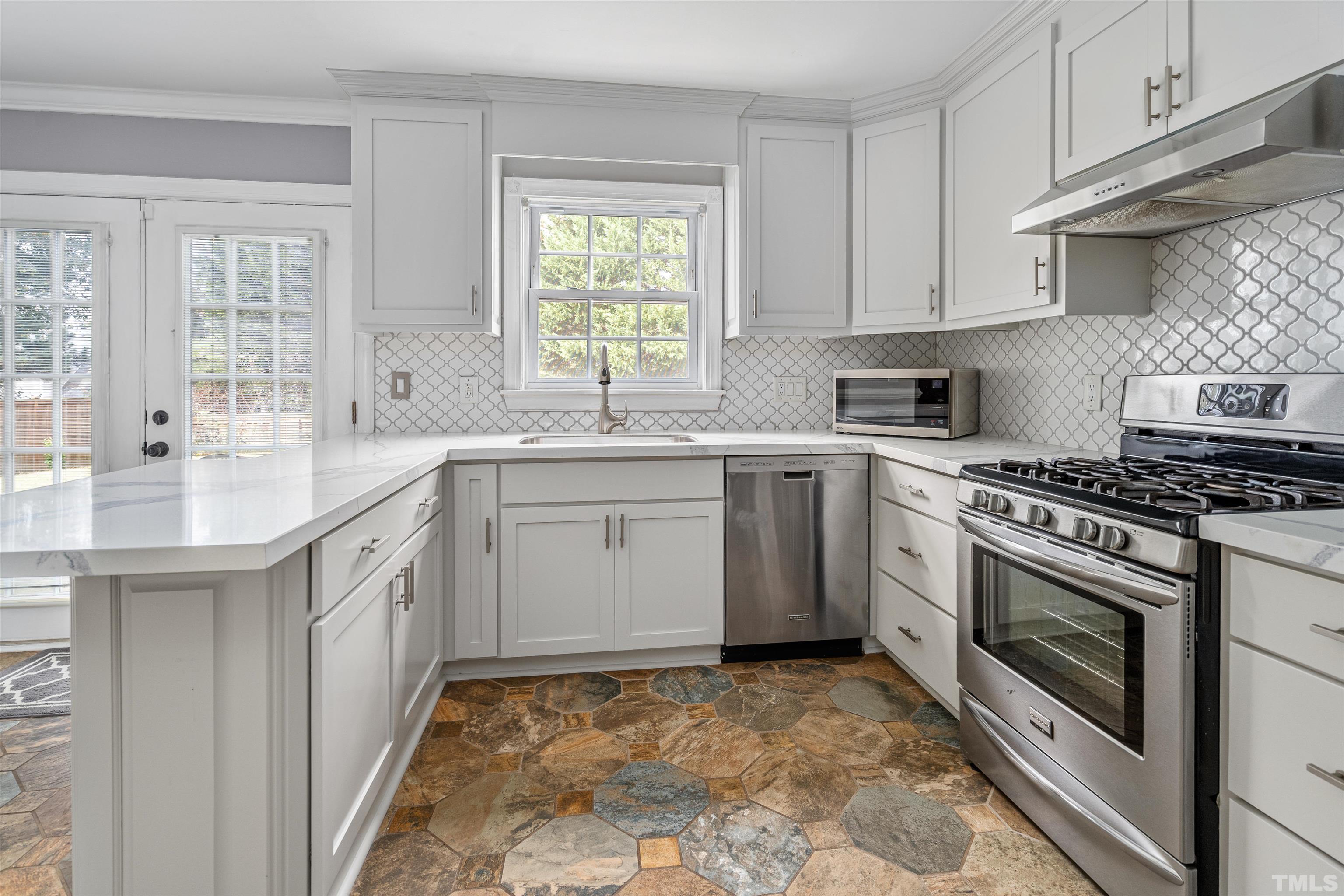5219 Cardinal Grove Boulevard Raleigh, NC 27616 - Photo 16 of 43 a kitchen with a stove sink and cabinets