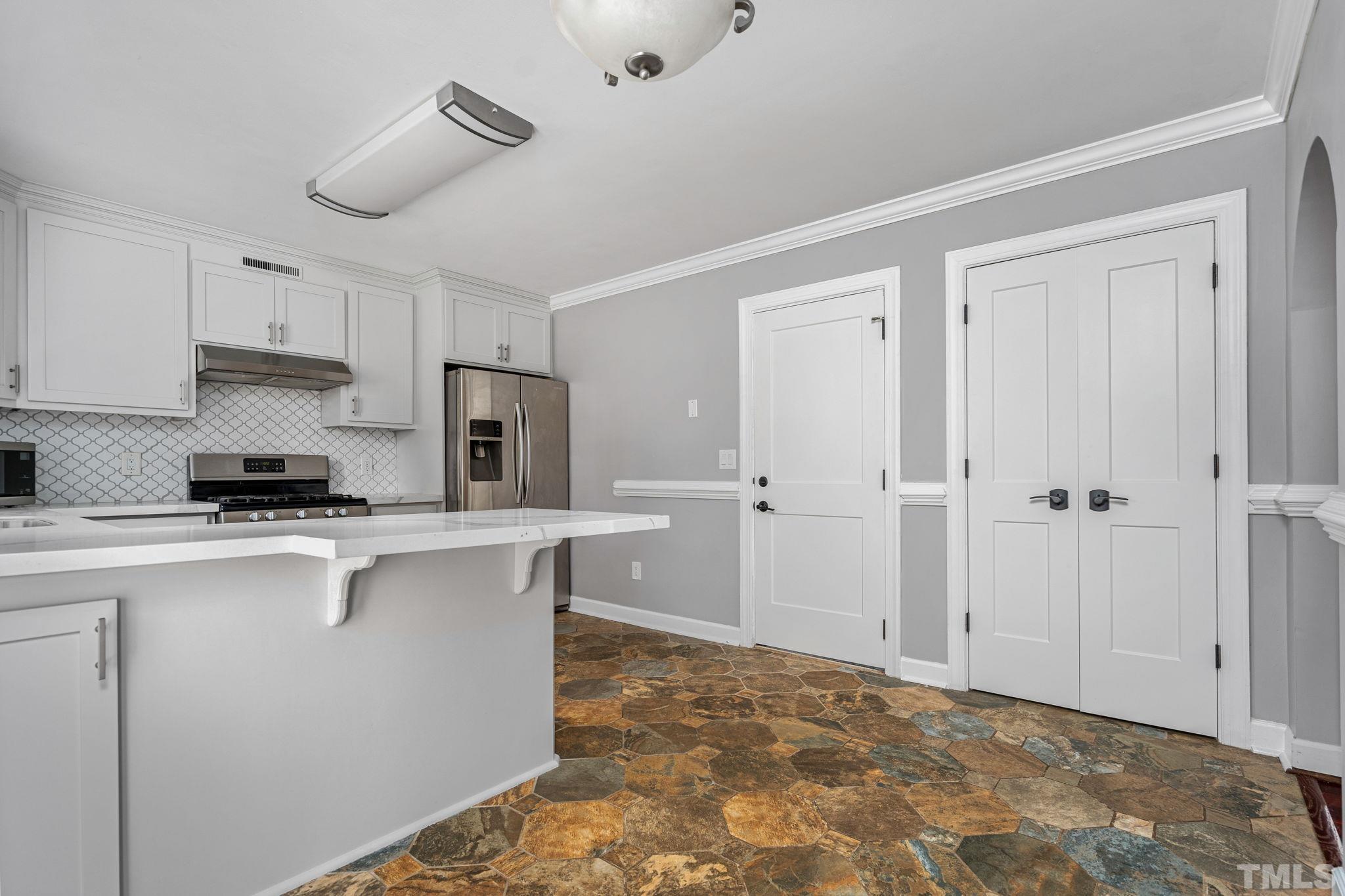 5219 Cardinal Grove Boulevard Raleigh, NC 27616 - Photo 19 of 43 a kitchen with stainless steel appliances a stove refrigerator sink and cabinets